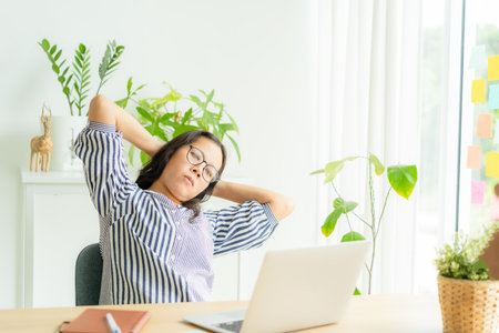 Asia woman touching massage stiff neck after sedentary computer work in incorrect posture, overworking for  long time,  exercises to relieve pain in muscles, Office syndrome concept, Copy spaceの写真素材