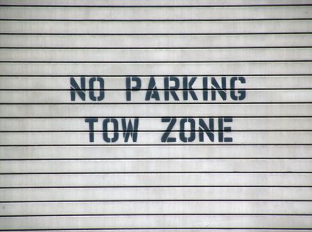 garage door sign no parking tow zone, black on gray with slatsの写真素材