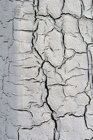 detail of aged and cracked paint on exterior corner wall thick paint peeling