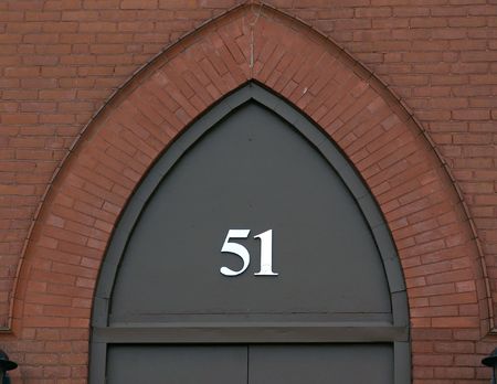 the number fifty one in metal numbers on archwat above door, surrounded by bricks, easthampton massachusettsの写真素材