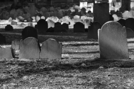 blank tombstones lit by the winter sun in the granary cemeteryの写真素材