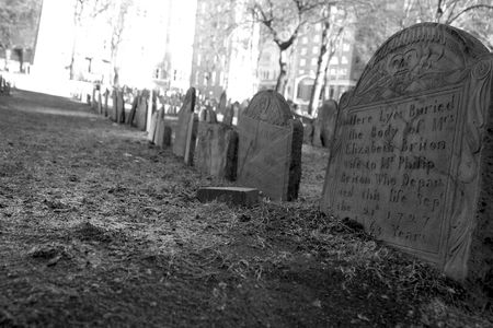 row of tombstones from the 1700's lead off into the distance in the granary cemetery, in boston massachusetts, one of america's oldest grave yardsの写真素材