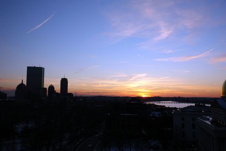 beautiful winter sunset over boston, a deep blue sky fades into the bright orange colors of sunsetの写真素材
