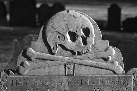 detail of old head stone in the granary burial ground in boston massachusetts dating back to 1660, here we see a skull with cross bones and an hourglassの写真素材