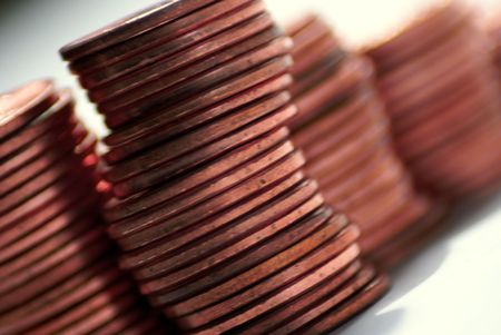 close up of stacks of pennies against a white backgroundの写真素材