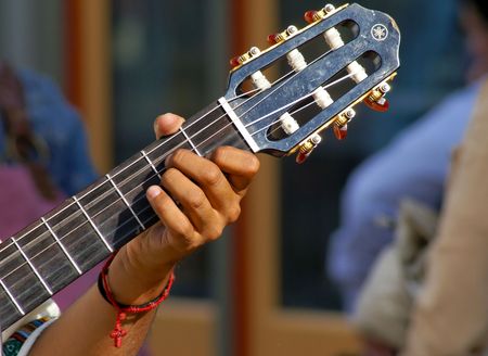 well lit image of man playing six string guitar