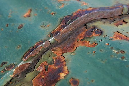 close up macro abstract shot of peeling paint and rust on old iron bridgeの写真素材