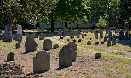 grave yard image showing old slate tombstonesand walking path in cambridge massachusettsの写真素材