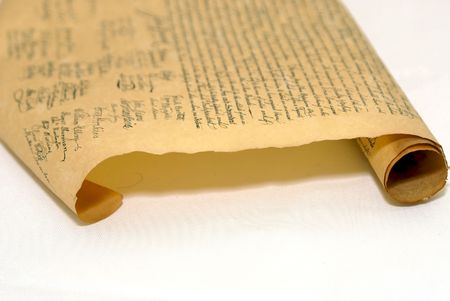 partilly rolled up copy of the declaration of independence on parchment paper, focus on the edge of...