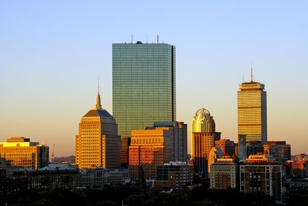 the warm color of the sun bathes the boston skyline on a cool autumn morningの写真素材