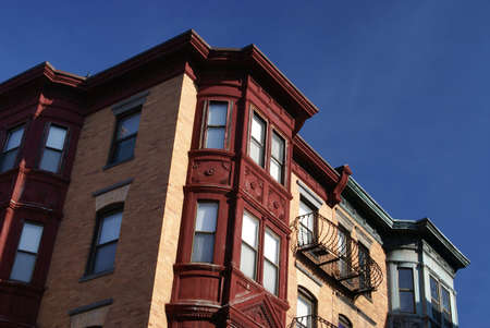 dramatic shot of upper floors of fancy old apartment building in downtown boston, emphasizing the red, white and blueの写真素材