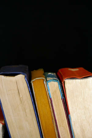 stack of old books on edge with bindings facing up