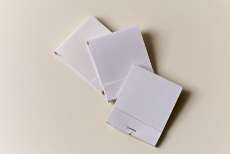 Three White Matchbooks On Off-White Surface, Books are blank to allow text and advertisingの写真素材