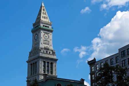 the clock on the custom house tower in boston massachusettts reads ten before two on a partly cloudy dayの写真素材
