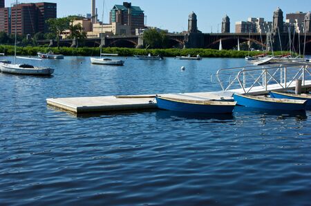 beautiful colorful scenic image of the charles river boat docks in boston massachusetts, with bridge and trai in backgroundの写真素材