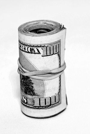 roll of money wrapped with an elastic on a  linen tablecloth giving a lightly textured background- could be easily isolatedの写真素材