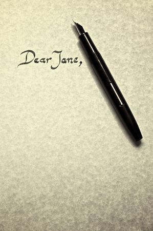 dear jane leter being written in calligraphy on parchment paper with pen