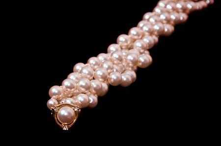 twisted strand of pearls on black with gold and diamondsの写真素材