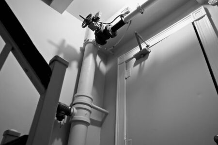 focus on sprinkler shut system above door in old stairwell の写真素材