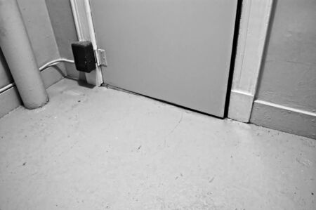 industrial building interior showing floor and bottom of doorの写真素材