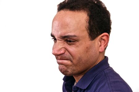 african american male wearing blue shirt against white background looking upset in profile