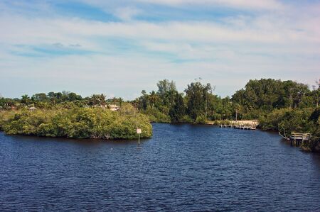 view of fork in river  with trees in background の写真素材