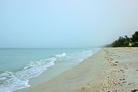 Looking down Bonita beach in Bonita Springs Florida on an early morning, fog is still in the distance.の写真素材