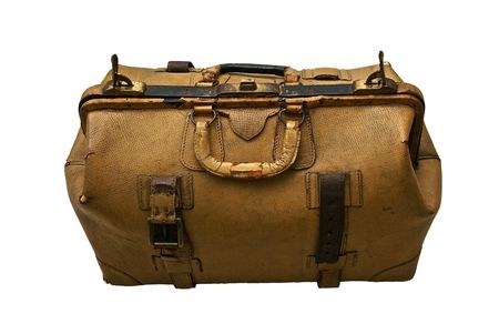 Large old suitcase  with lock made of  tan colored leather, the leather is old and cracked and the straps are broken, isolated on whiteの写真素材