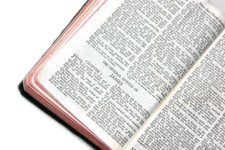 holy bible open to the epistle of james, on white background