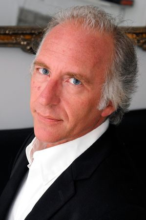 three quarter face portrait of handsome professional blue eyed older man.の写真素材