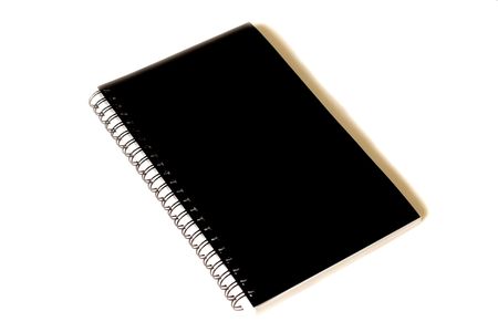 a closed notebook with spiral binding and black cover on whiteの写真素材