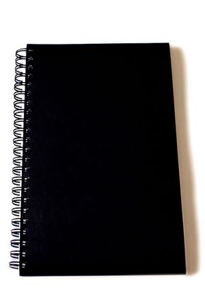 a closed notebook with spiral binding and black cover on whiteの写真素材