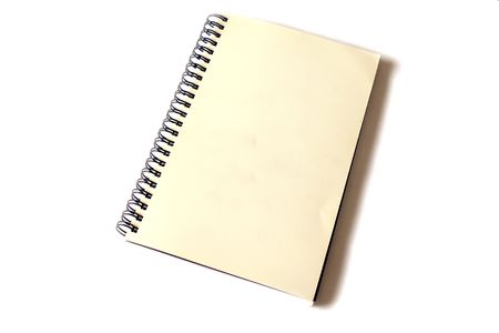 aged spiral bound notebook on white backgroundの写真素材