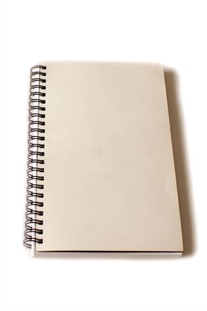 old yellowed note book on white with blank cover.の写真素材
