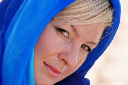 beautiful flirtatious  looking blonde woman is giving a sideways glance to the viewer with her head tiltedの写真素材