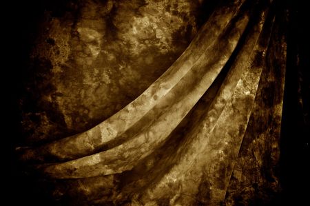 Draped mottled sepia tie dyed backdrop fabric.の写真素材