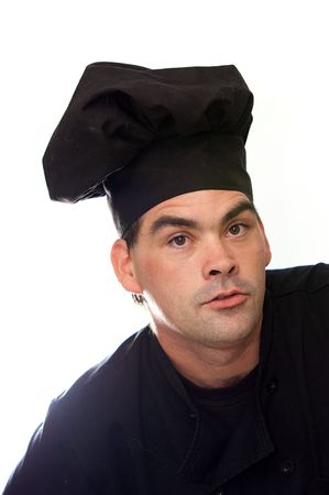 adult male chef in black uniform looking directly at viewerの写真素材