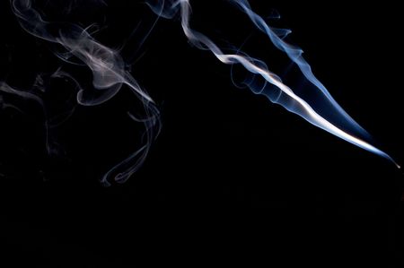 a wispy cloud of real incense smoke floats across the image and appears to form a lion's face.の写真素材