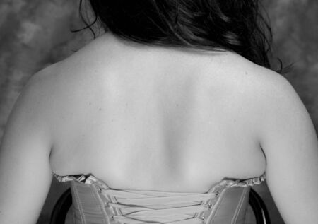 black and white image of caucasian woman's shoulders and backの写真素材