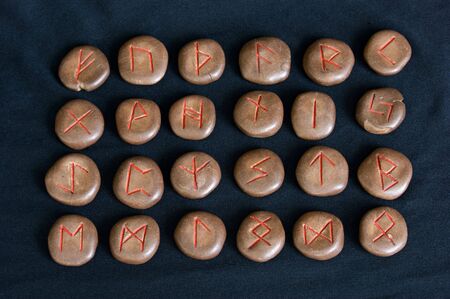 complete ancient germanic alphabet or runes on black cloth, this set was made by the photographerの写真素材