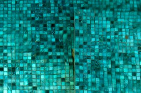 Small ceramic tiles are distorted by the movement of water covering them.の写真素材