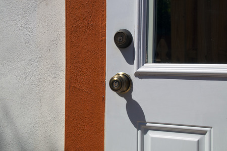 Detail of door with door knob and deadbolt on typical florida home.の写真素材