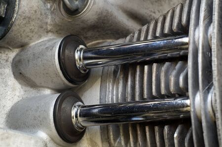 Detail of motorcycle engine aluminum head and chrome covered push rods.