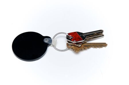 Keyring with assorted keys with blank, round black fob for text.の写真素材