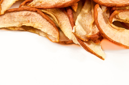 Looking down on a white plate with dried apple slices up close. Not isolated with copy space.