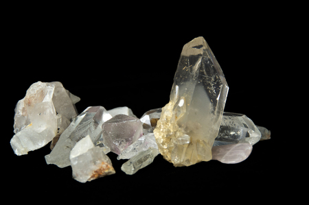 Numerous large clear quartz crystal points on black background, surface level and up close on black background.の写真素材