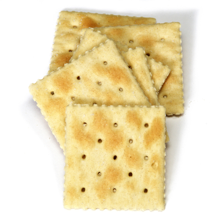 Looking down at stack of soda crackers, also known as soup crackers and saltines over white, not isolated.の写真素材