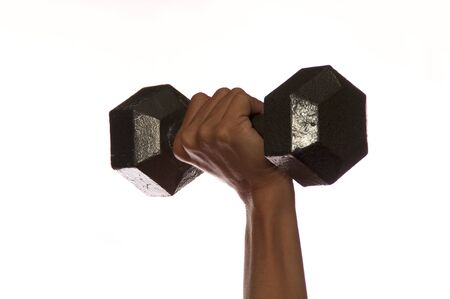 Close up of woman weightlifter's hand and wrist lifting metal weight straight up against white.の写真素材