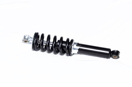 shiny new black and silver motorcycle shock absorber over white, this shock is also used on ATVs.の写真素材
