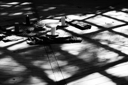 Black and white candle lit image with deep shadows, showing center of pagan mayan ceremonial...